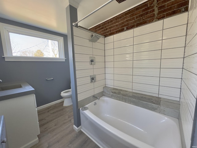 full bath featuring baseboards, shower / washtub combination, toilet, wood finished floors, and vanity