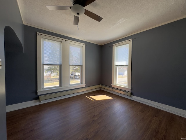 unfurnished room featuring a ceiling fan, wood finished floors, baseboards, ornamental molding, and a textured ceiling