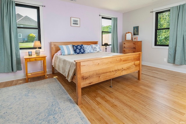 bedroom with wood finished floors and baseboards