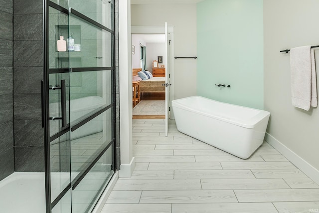 ensuite bathroom with a soaking tub, wood tiled floor, a shower stall, and connected bathroom