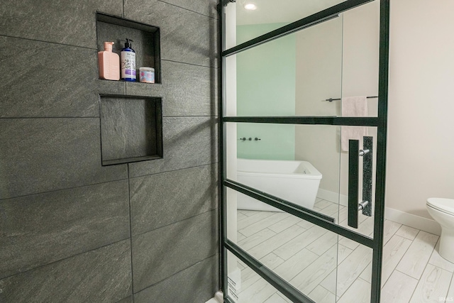 bathroom featuring toilet and baseboards