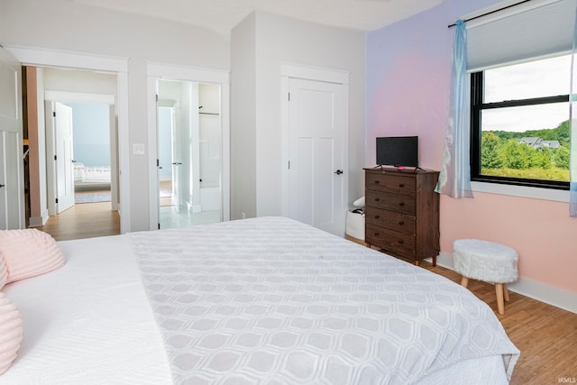 bedroom featuring wood finished floors and baseboards