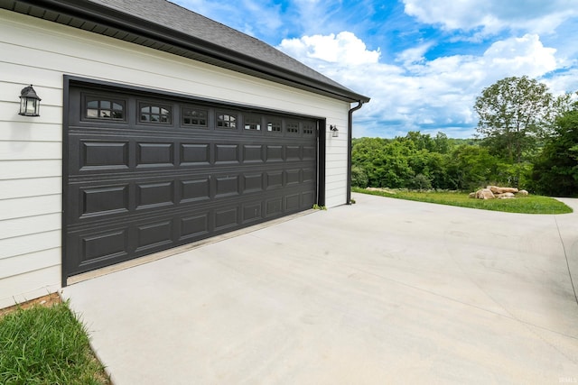 garage featuring concrete driveway