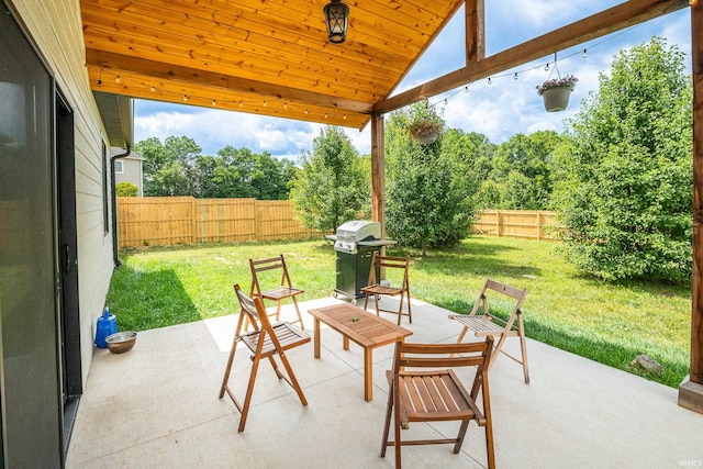 view of patio with grilling area and a fenced backyard