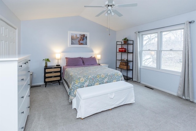 bedroom featuring visible vents, baseboards, ceiling fan, vaulted ceiling, and light colored carpet