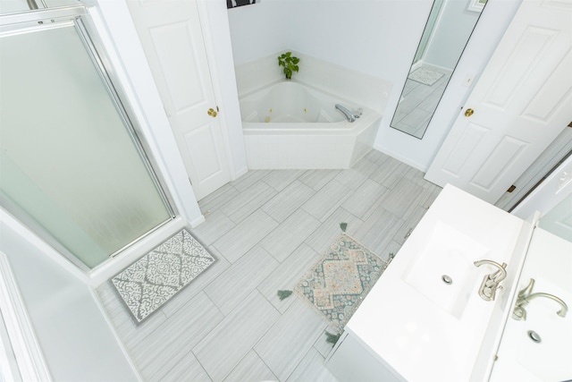 bathroom featuring an enclosed shower and a whirlpool tub