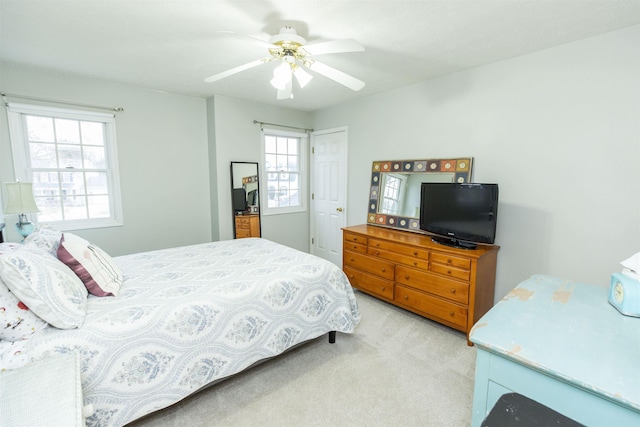 bedroom with light colored carpet and ceiling fan