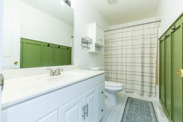 bathroom featuring vanity, tile patterned floors, toilet, and visible vents