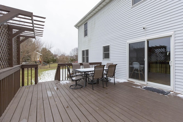 deck with outdoor dining area, a pergola, and a playground