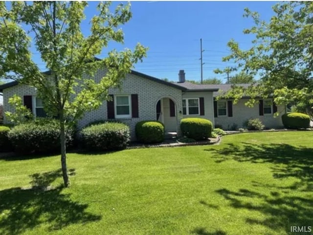 ranch-style home with brick siding and a front yard