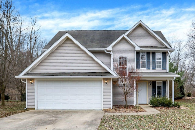 traditional home featuring concrete driveway, an attached garage, and roof with shingles