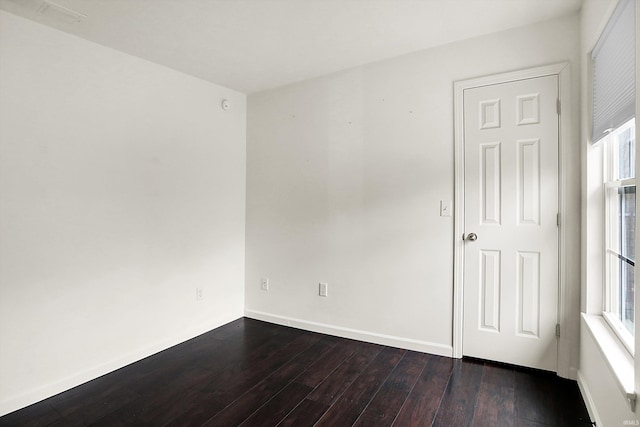 904 S Deer Run, Ellettsville, IN 47429 - spare room featuring dark wood-type flooring and baseboards