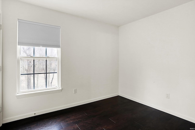 904 S Deer Run, Ellettsville, IN 47429 - spare room featuring baseboards and dark wood-style flooring