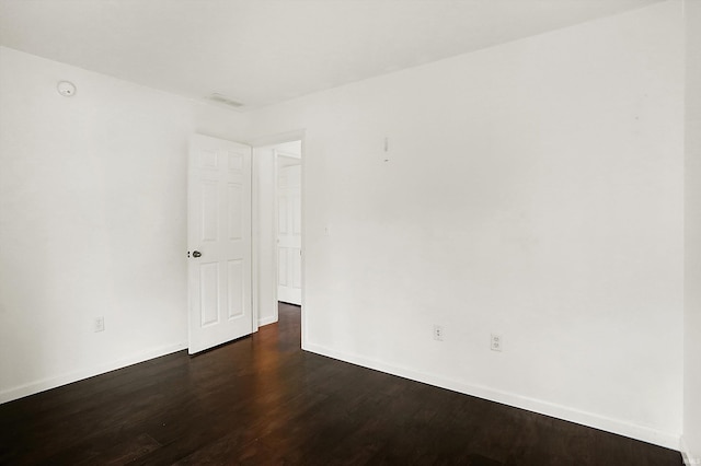 904 S Deer Run, Ellettsville, IN 47429 - spare room featuring dark wood-style floors, visible vents, and baseboards