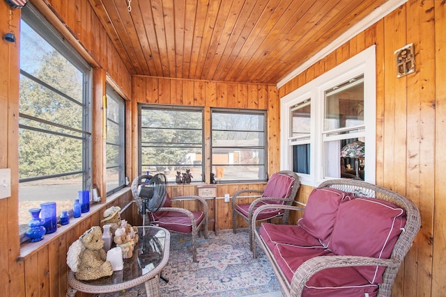 sunroom / solarium featuring a healthy amount of sunlight and wooden ceiling