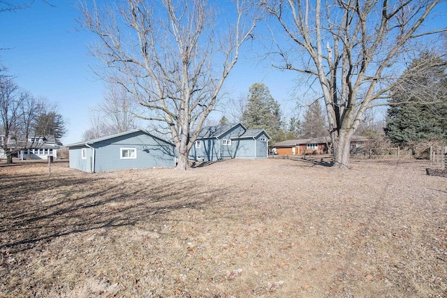 view of yard featuring driveway and a garage