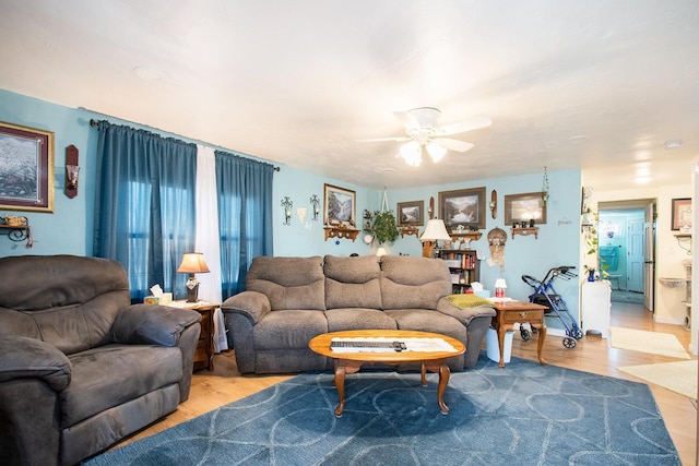 living area featuring ceiling fan and wood finished floors