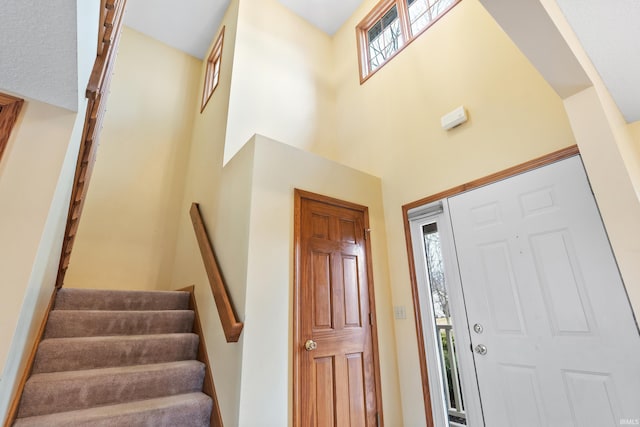 foyer with a high ceiling and stairs