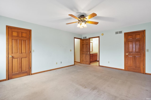 unfurnished bedroom featuring visible vents, light carpet, and baseboards