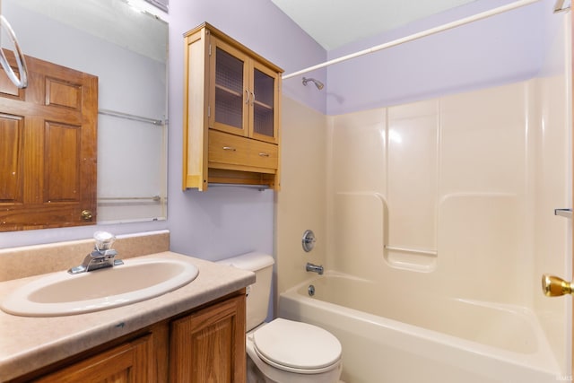 bathroom with bathtub / shower combination, toilet, and vanity