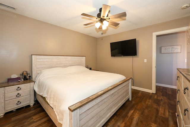 bedroom with visible vents, a ceiling fan, baseboards, and dark wood-style flooring