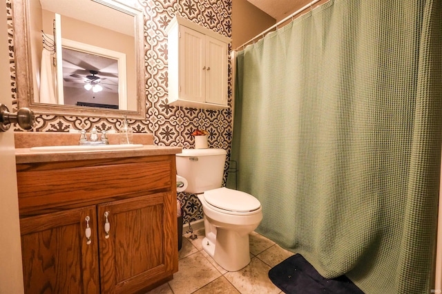 bathroom featuring wallpapered walls, toilet, vanity, and tile patterned flooring