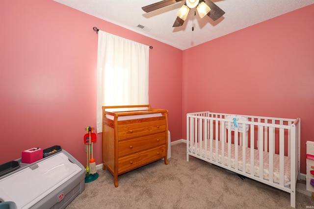 bedroom with baseboards, carpet flooring, a ceiling fan, and visible vents