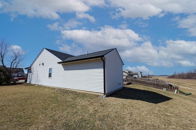 view of side of home with a lawn