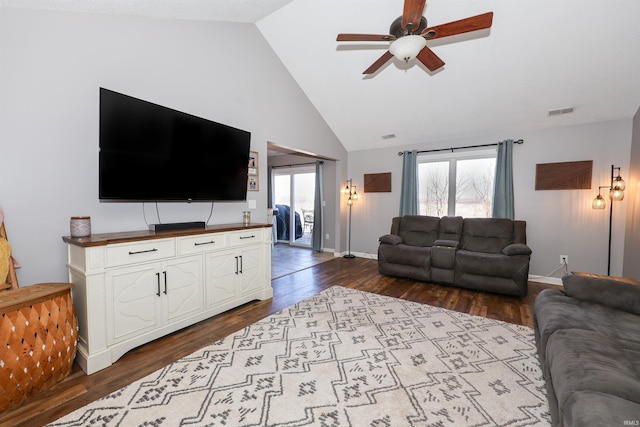 living area featuring visible vents, dark wood-type flooring, a healthy amount of sunlight, and a ceiling fan