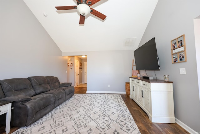 living room with ceiling fan, baseboards, dark wood finished floors, and vaulted ceiling