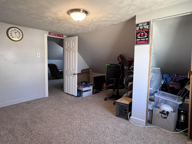 carpeted bedroom with a textured ceiling and baseboards