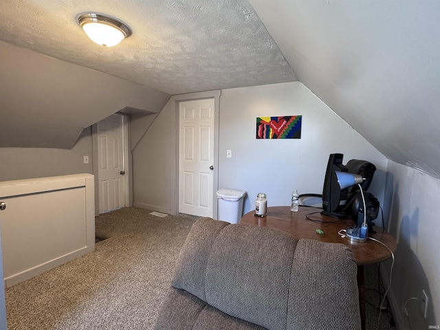 carpeted bedroom featuring lofted ceiling and a textured ceiling