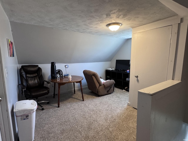 living area with lofted ceiling, light colored carpet, baseboards, and a textured ceiling