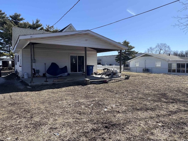 back of property featuring a patio area and fence