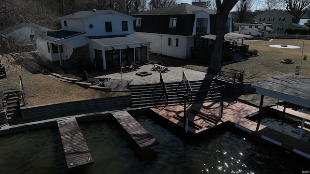 rear view of property with a patio area and an outdoor fire pit