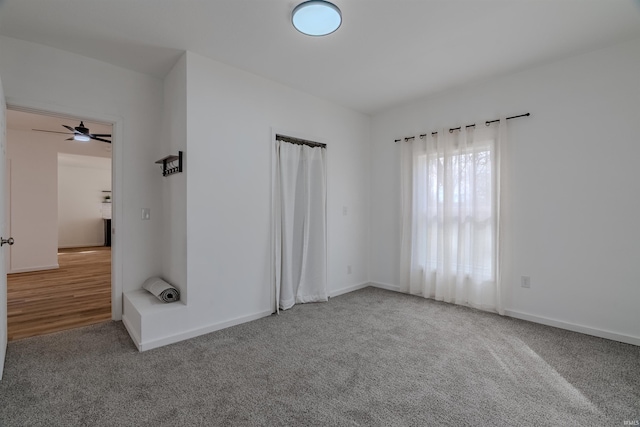 spare room with carpet and baseboards