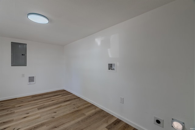 laundry area featuring visible vents, electric panel, wood finished floors, hookup for a washing machine, and laundry area