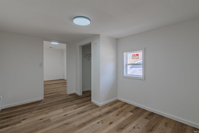 empty room featuring baseboards and wood finished floors