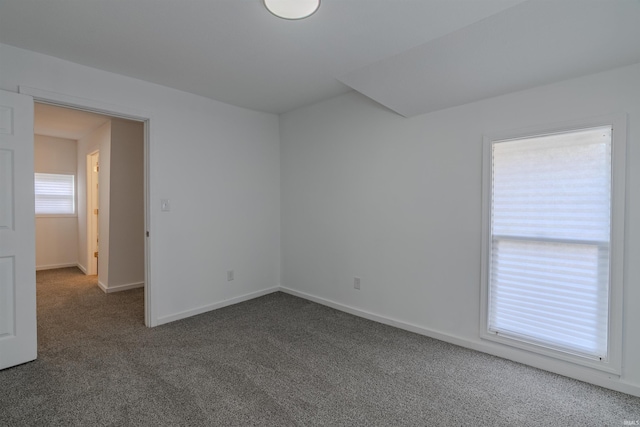 carpeted spare room with baseboards