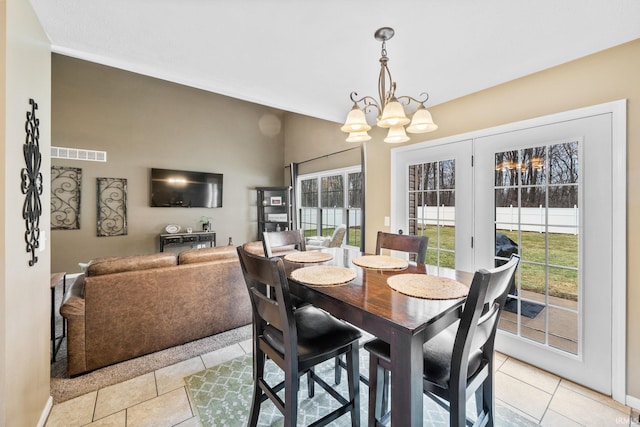 dining area with a chandelier, visible vents, and light tile patterned floors