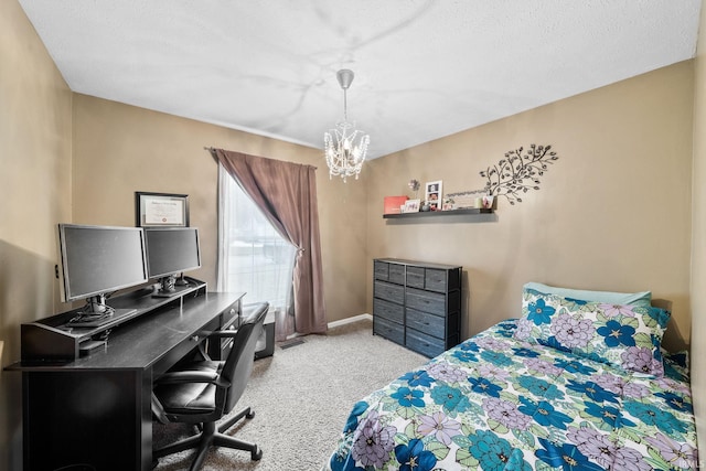 carpeted bedroom featuring baseboards and a chandelier