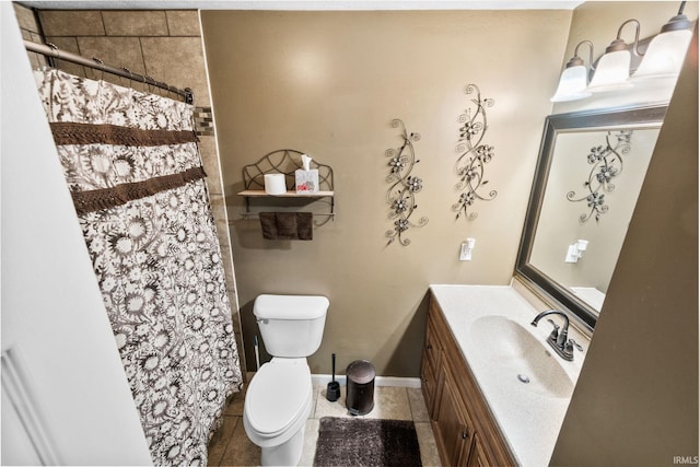 bathroom with tile patterned floors, toilet, vanity, and baseboards