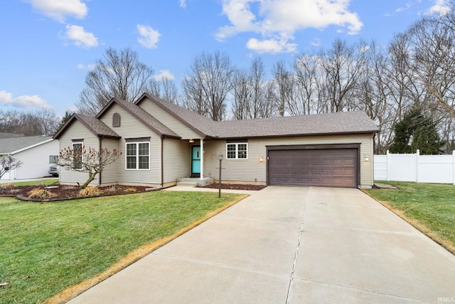 ranch-style home featuring a front lawn, an attached garage, fence, and concrete driveway