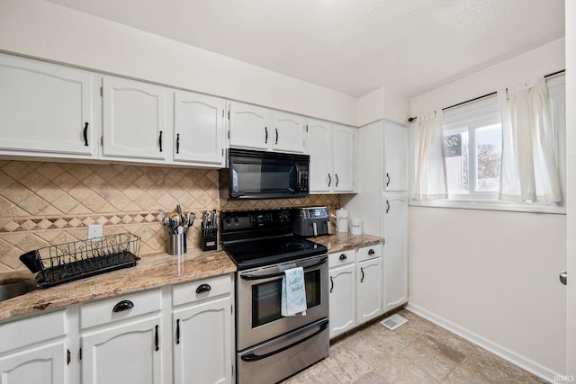 kitchen featuring backsplash, baseboards, black microwave, stainless steel electric range oven, and white cabinets