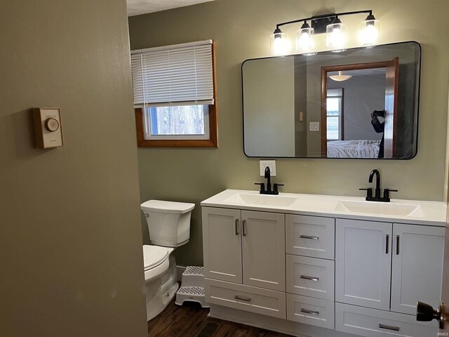 full bath with double vanity, toilet, ensuite bathroom, and a sink