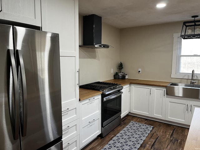 kitchen featuring a sink, stainless steel appliances, wood counters, and ventilation hood