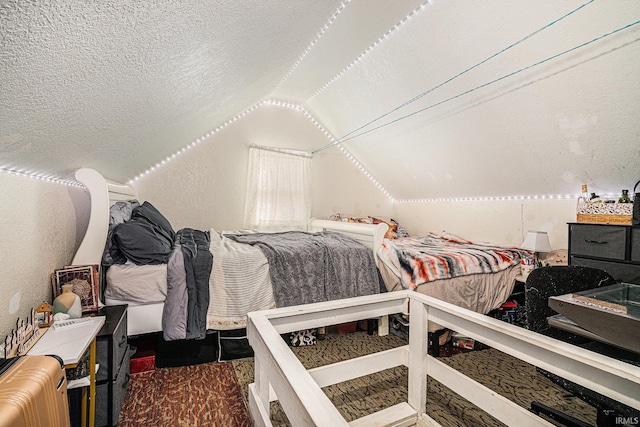 bedroom with a textured ceiling, lofted ceiling, and a textured wall