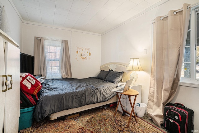 bedroom with multiple windows and crown molding