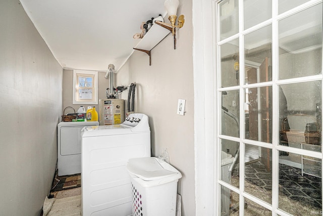 laundry room with water heater, laundry area, and independent washer and dryer