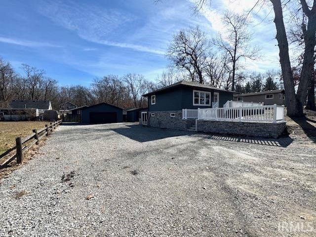 exterior space featuring an outbuilding and gravel driveway